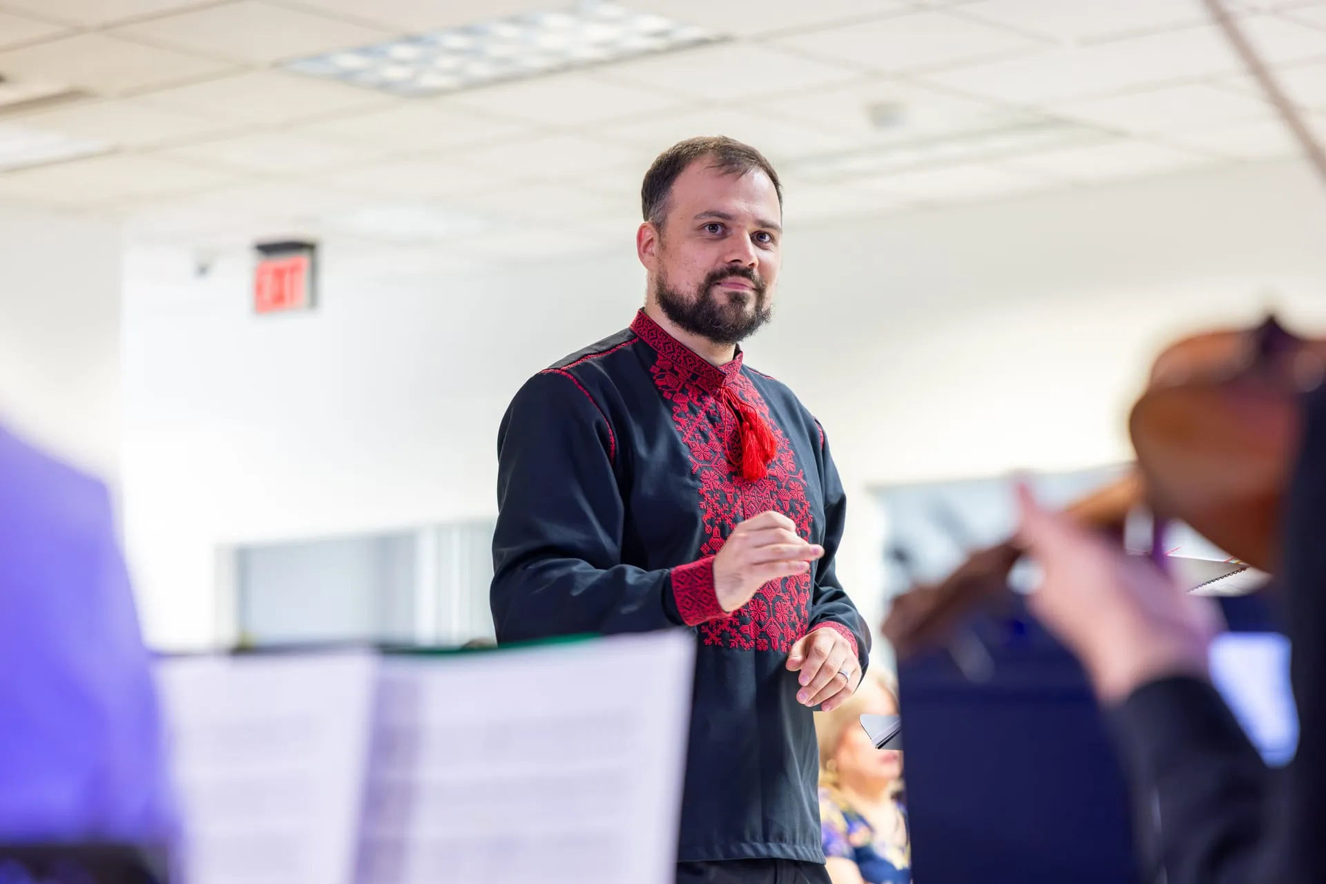 Tar Sahno conducting the neoclassical folk ensemble, violin in the foreground