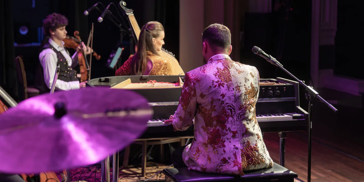 Tar Sahno at the piano, with a purple cymbal in front and the bandura behind